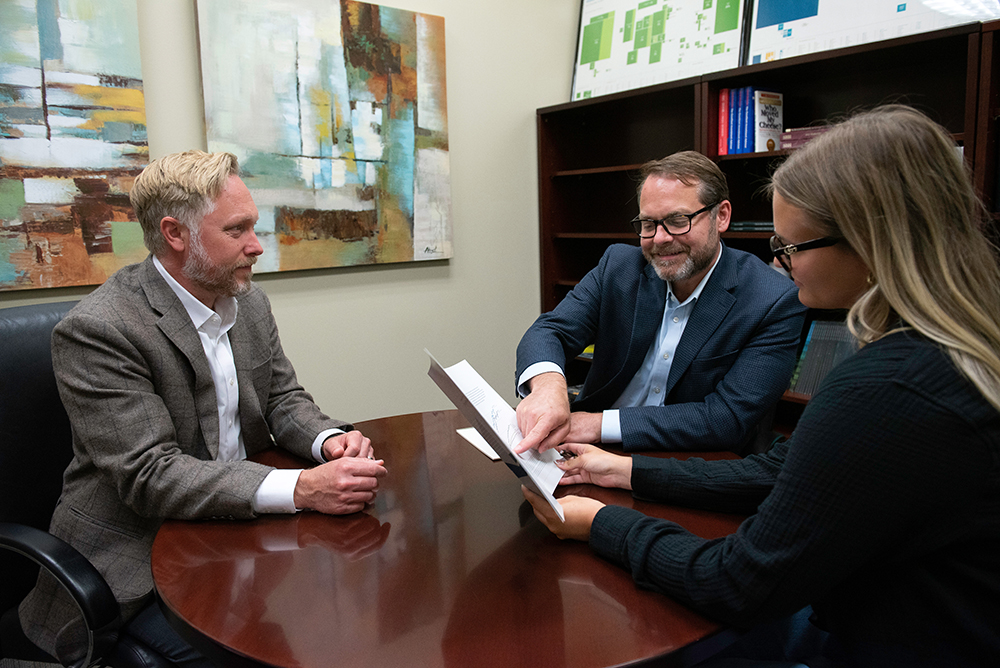 Allodium team members reviewing financial planning documents