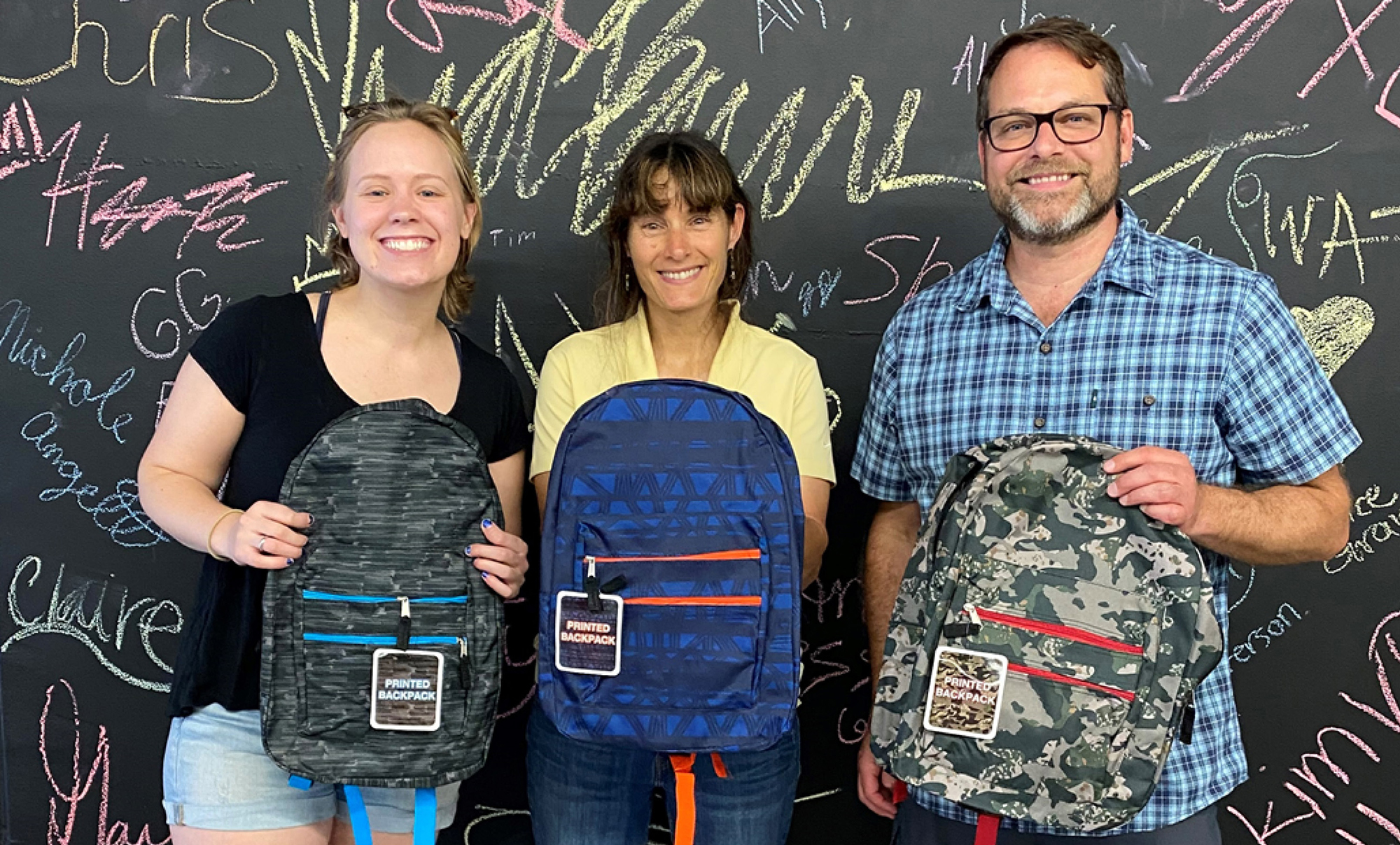 Allodium team members volunteering at a community backpack drive