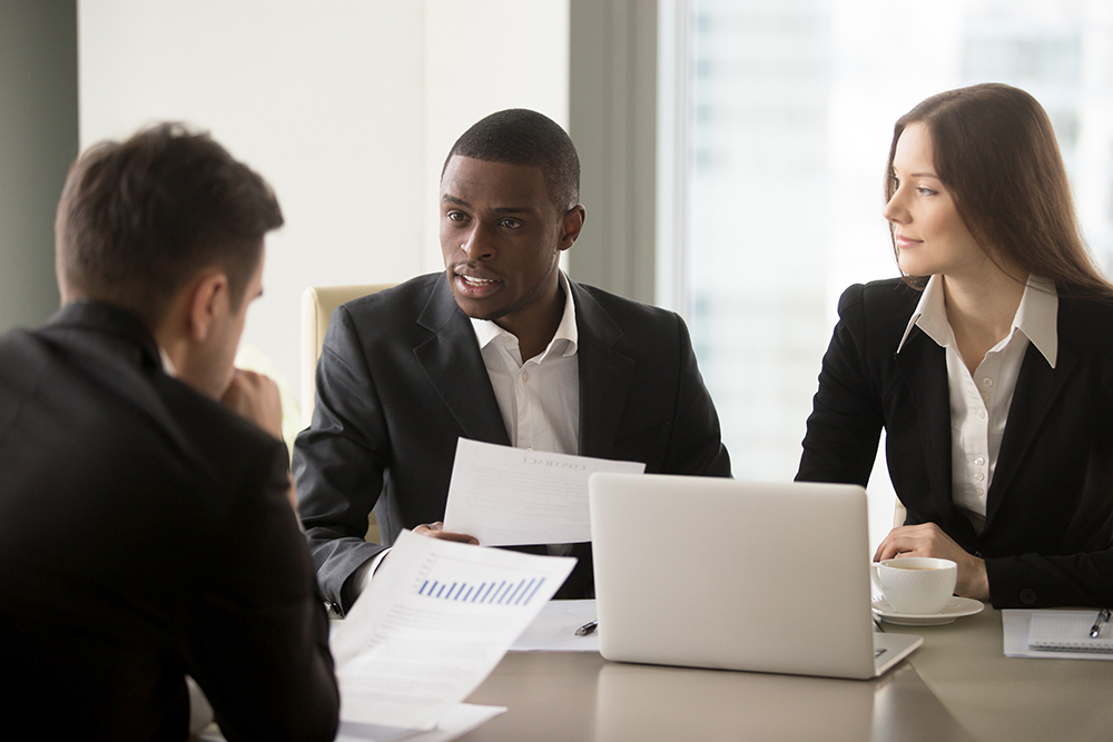 Investment managers sitting at a table